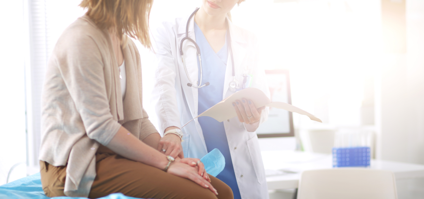 Doctor and patient discussing something while sitting at the table . Medicine and health care concept. Doctor and patient